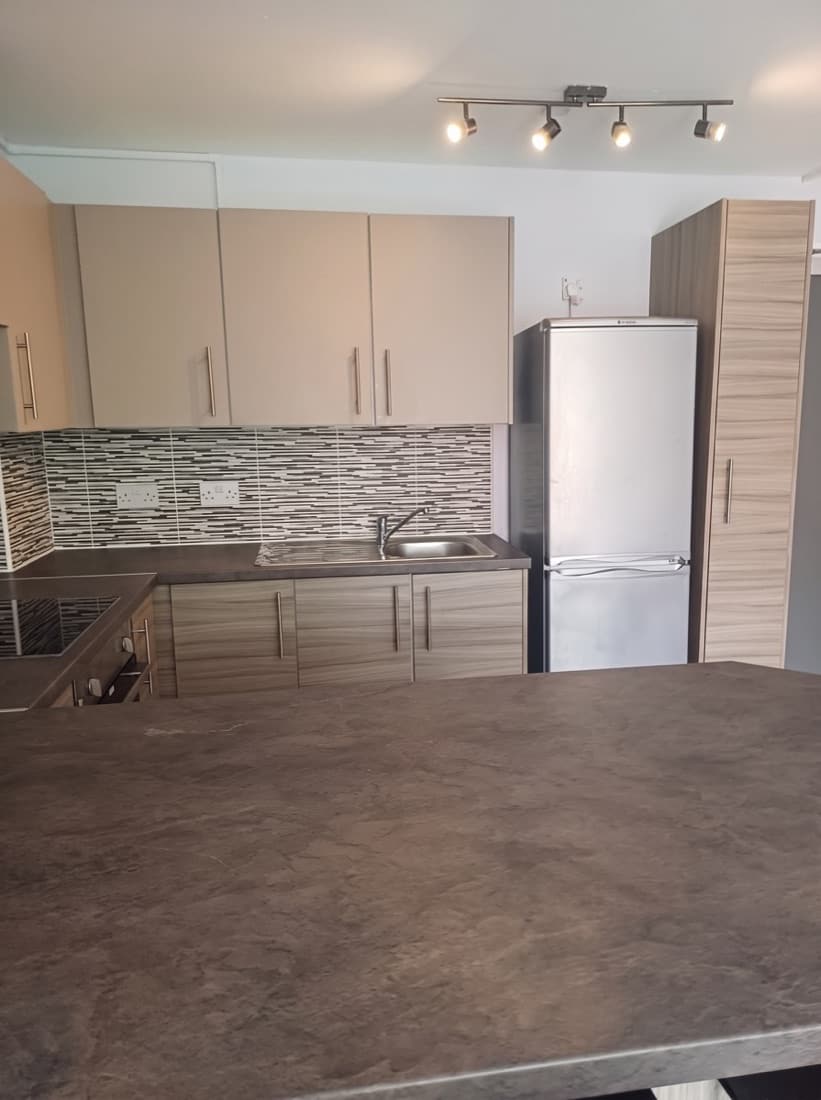 The same kitchen after our end of tenancy clean — units, worktops and appliances