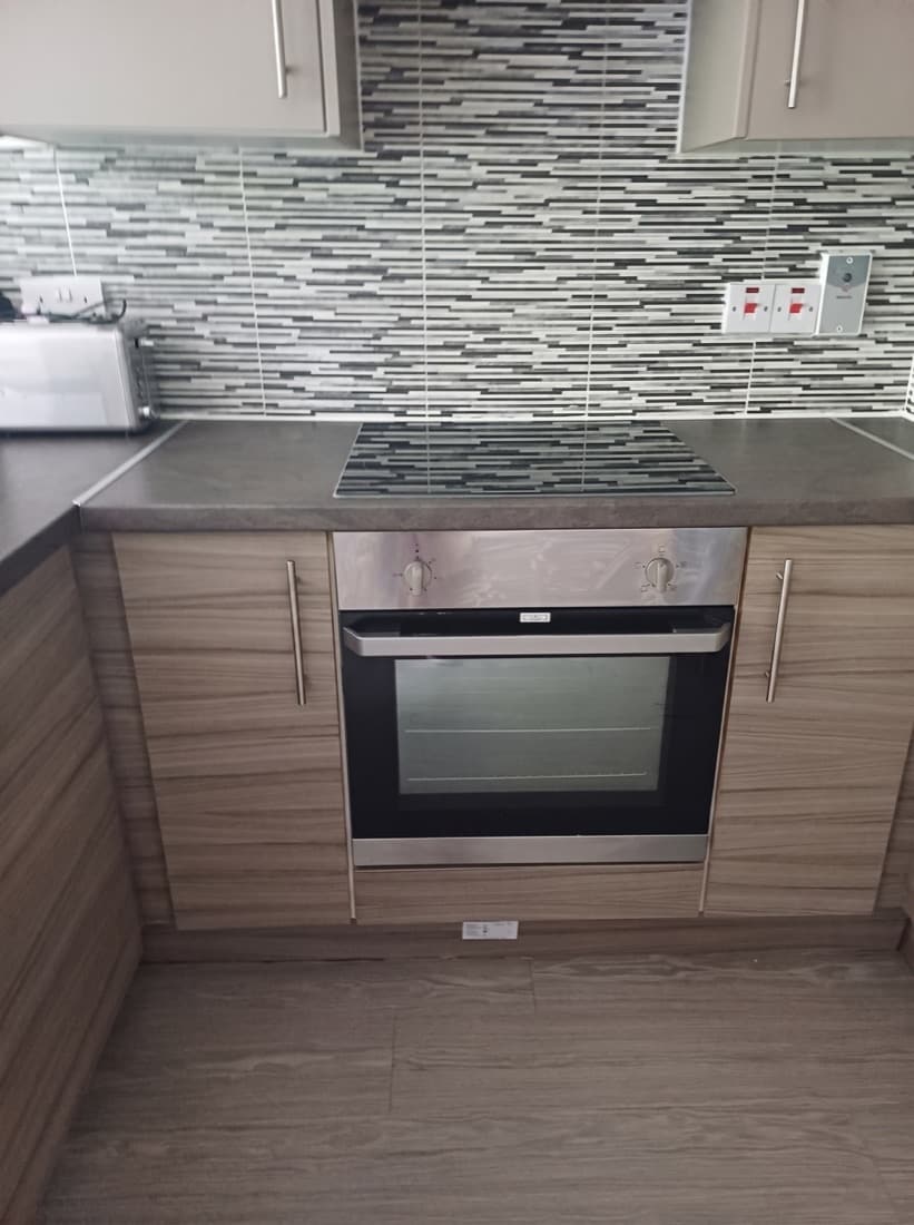 The same kitchen after our clean — spotless oven, hob and worktop