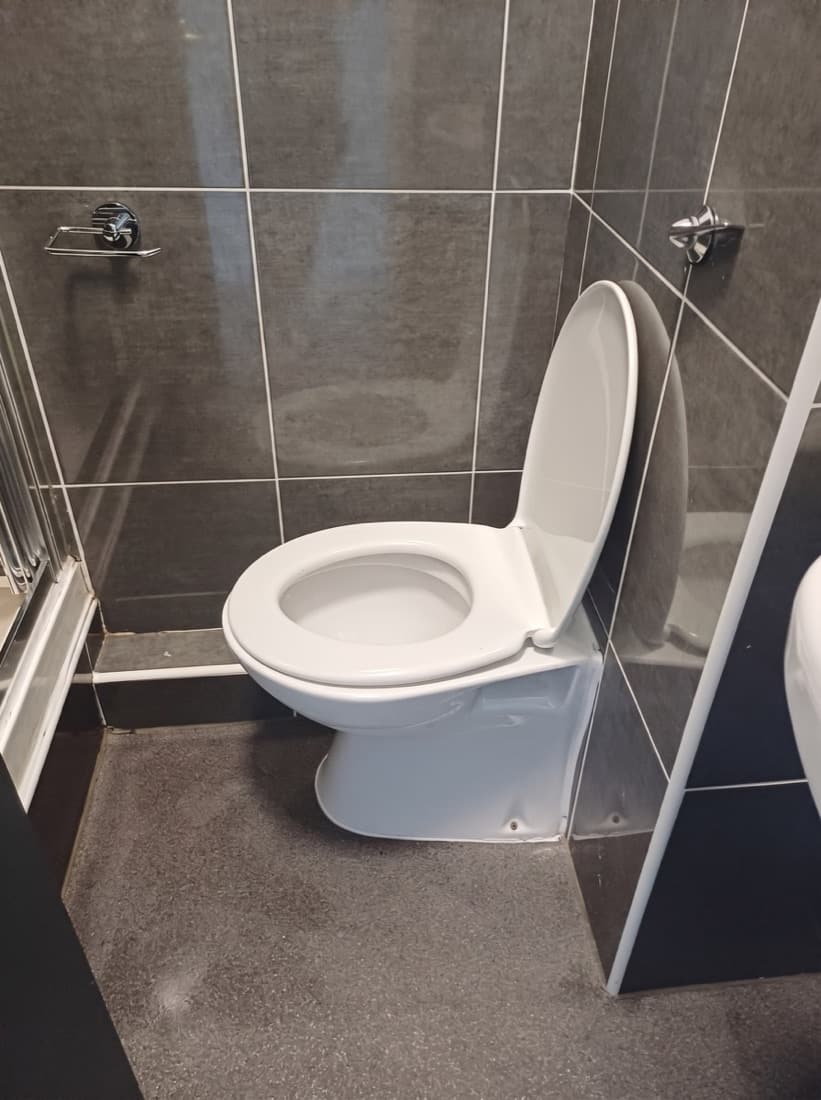 The same toilet after our deep clean — spotless white ceramic